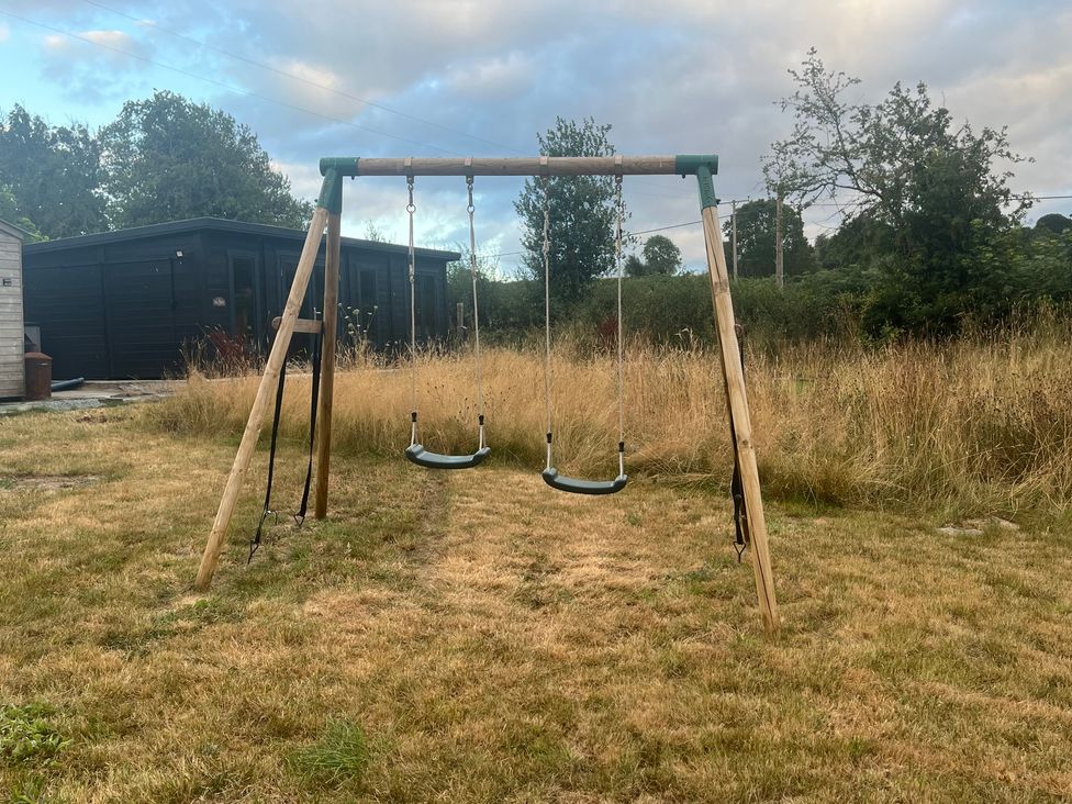 A swing set in a garden at Grove Cottage in Gladestry
