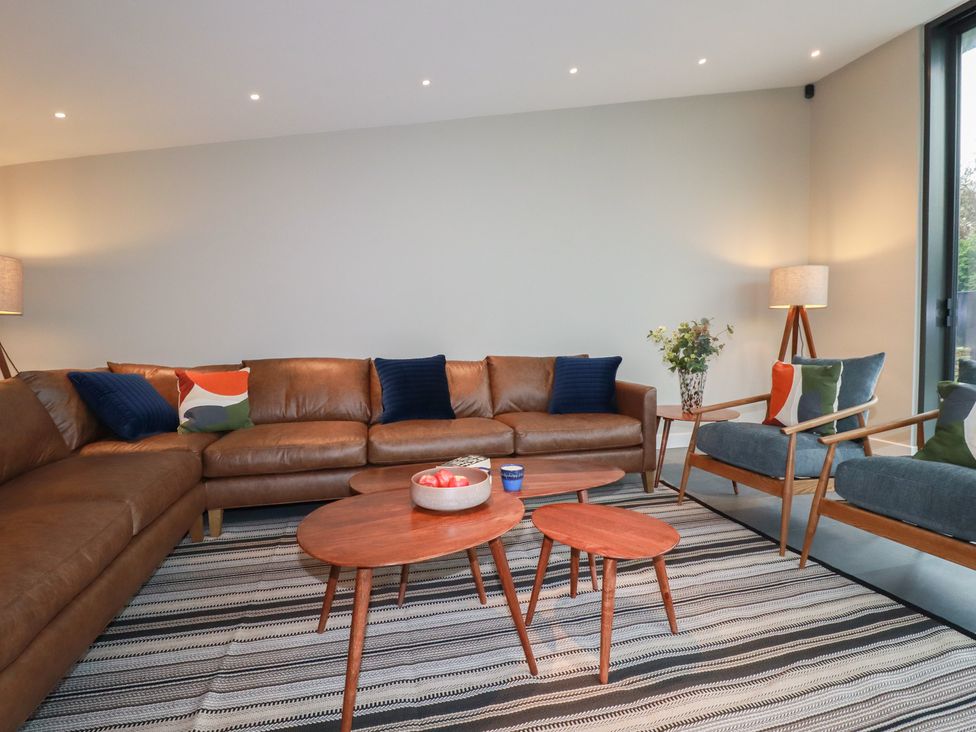 A living room with a sofa and coffee tables at Harberton