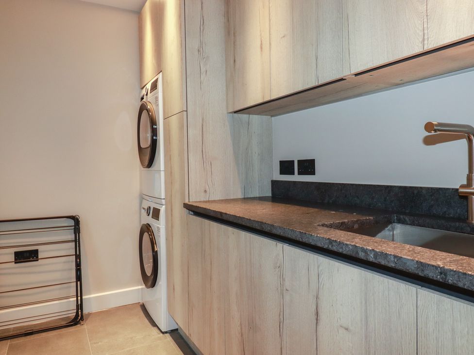 A laundry room with a washer and dryer at Harberton