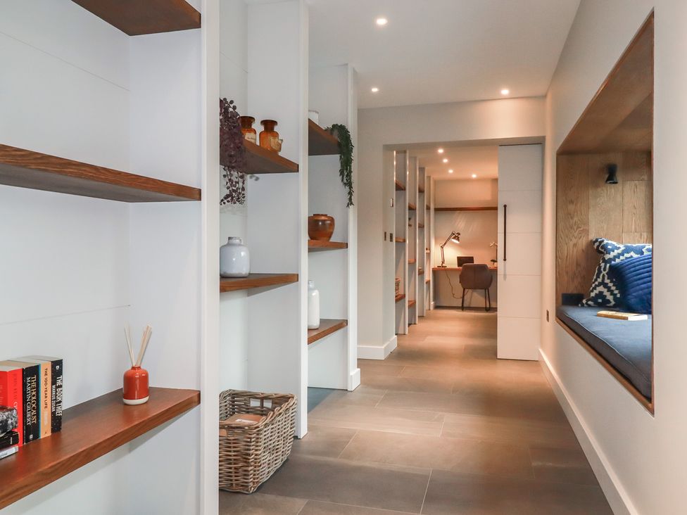 A hallway with shelves and a desk at Harberton