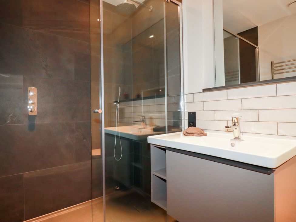 A bathroom with a shower and sink at Harberton