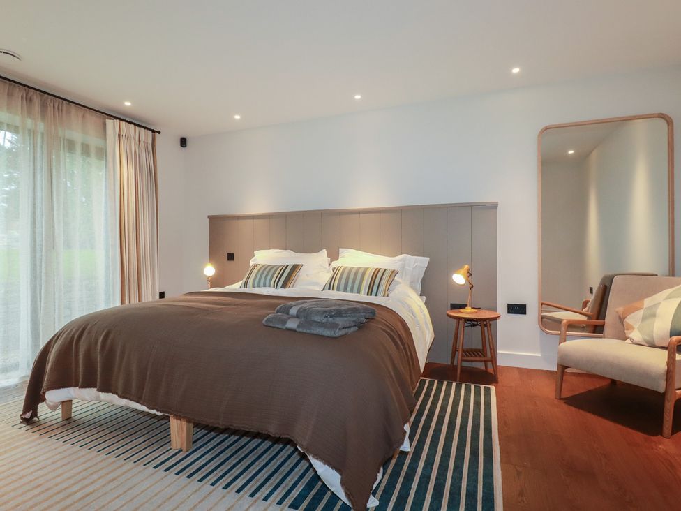 A bedroom with a bed and a chair at Harberton