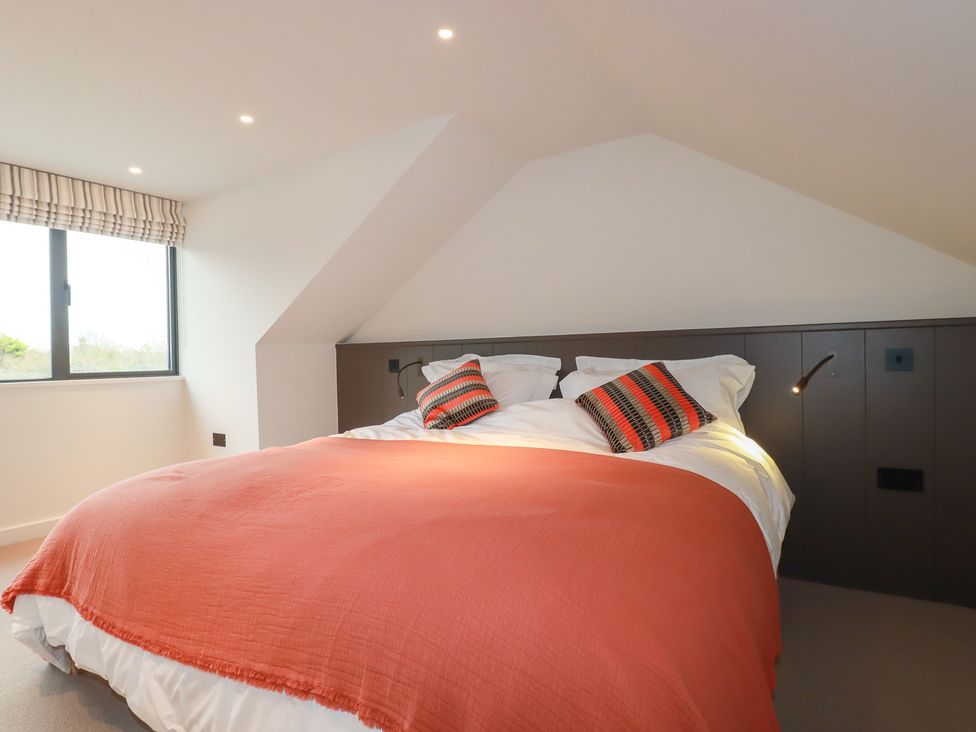 A bedroom with a bed and window at Harberton