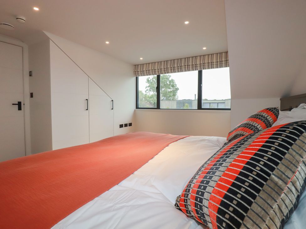 A bedroom with a bed and wardrobe at Harberton