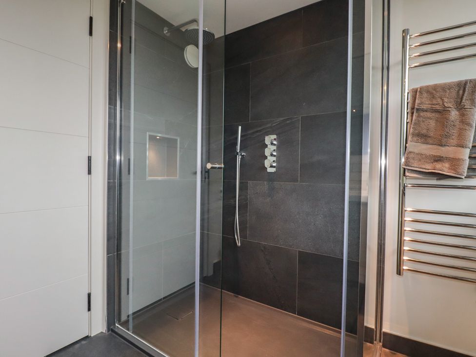 A shower with glass enclosure at Harberton