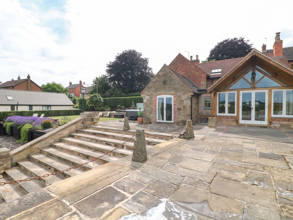 An outdoor area with stone steps and patio at New Elms Farmhouse in Melbourne, Derbyshire