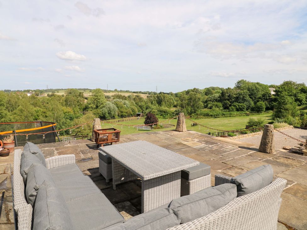 A garden with outdoor furniture and landscape view at New Elms Farmhouse in Melbourne, Derbyshire