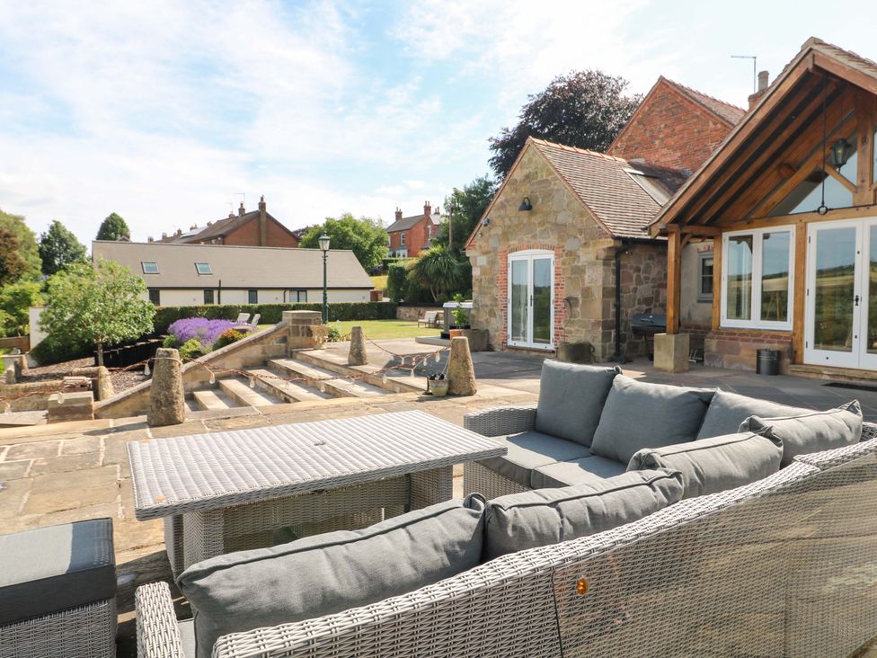 A patio with seating and a table at New Elms Farmhouse in Melbourne, Derbyshire