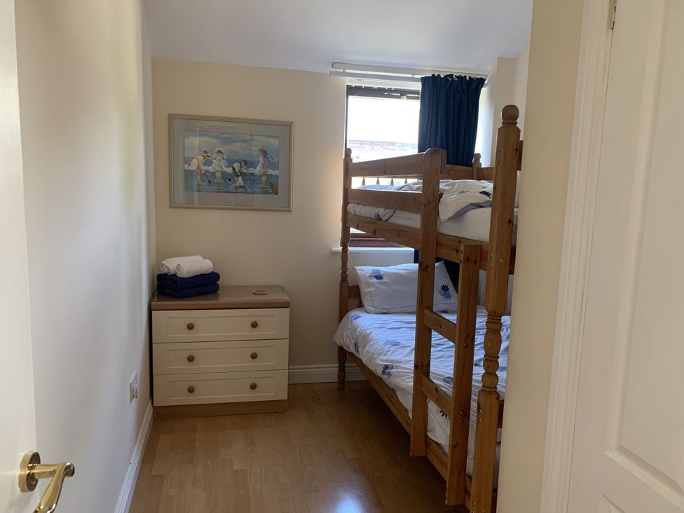 A bedroom with a bunk bed and drawer unit at Millers Cottage Seaville near Wigton