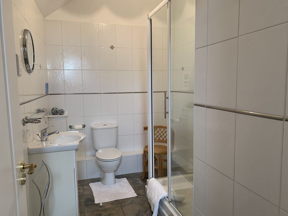 A bathroom with a shower and sink at Millers Cottage near Wigton