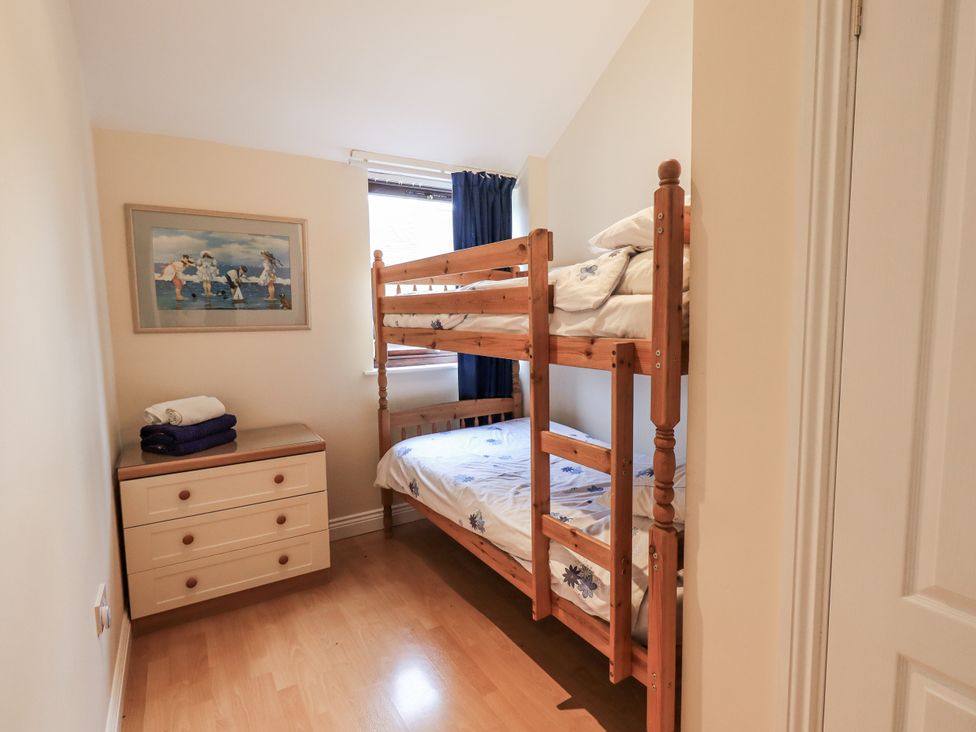 A bedroom with a bunk bed and dresser at Millers Cottage Seaville near Wigton