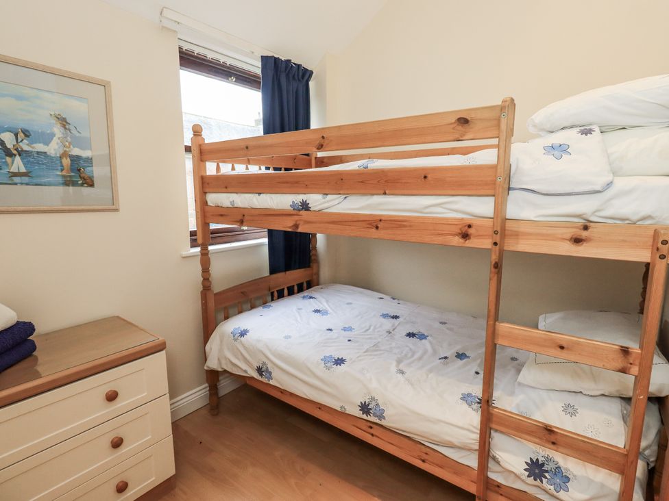 A bedroom with a bunk bed and a dressing table at Millers Cottage near Wigton