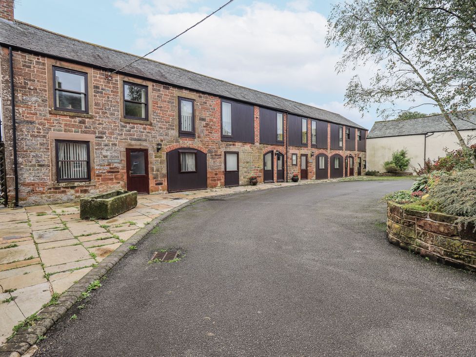 A building with multiple windows and doors at The Hayloft near Wigton