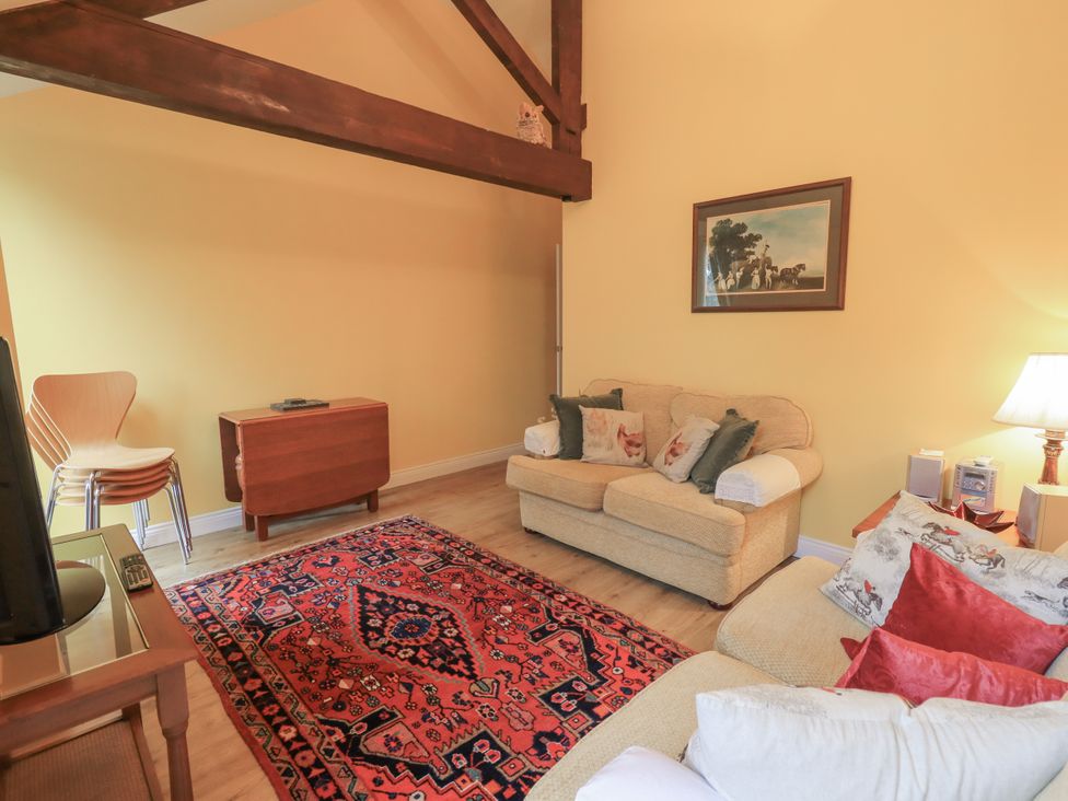 A living room with a sofa and armchair at The Hayloft near Wigton