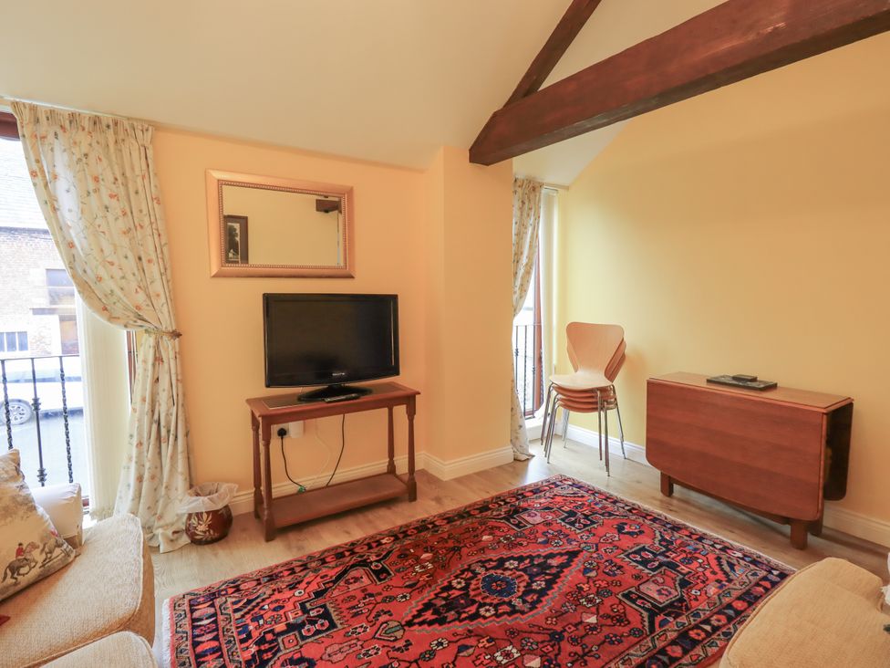 A living room with a sofa and television at The Hayloft near Wigton