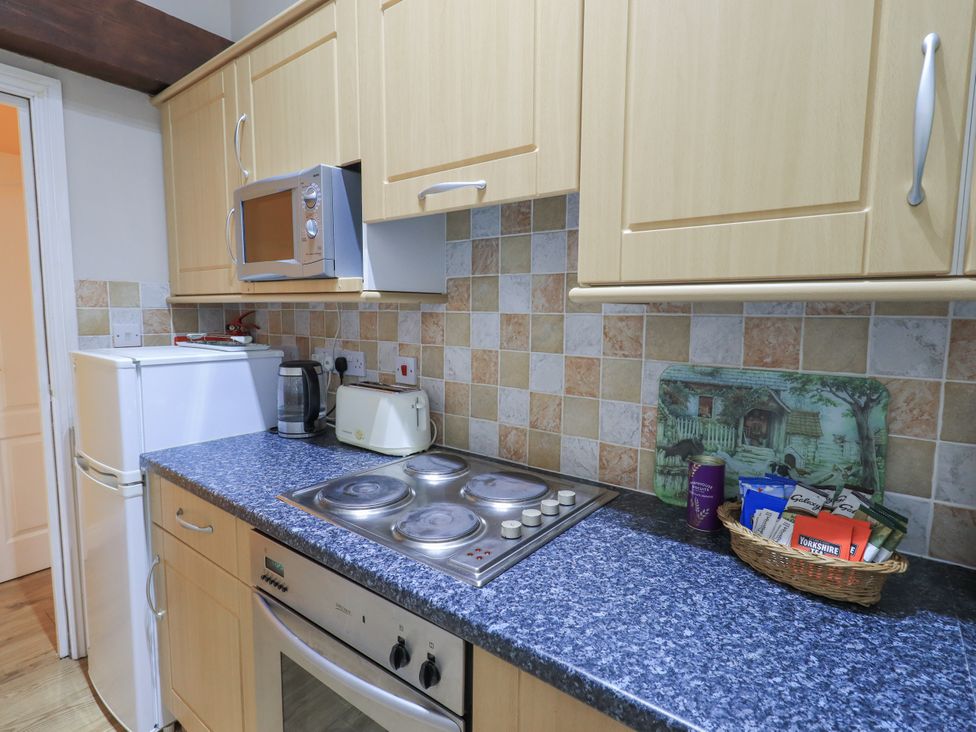 A kitchen with a microwave and fridge at The Hayloft near Wigton