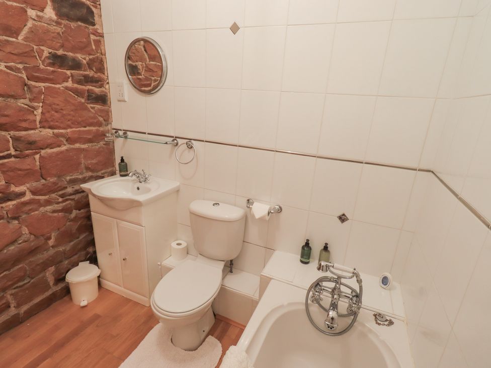 A bathroom with a sink, toilet, and bathtub at The Hayloft near Wigton