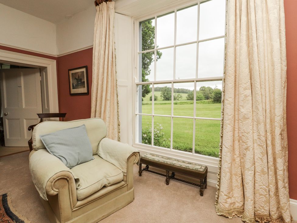 A living room with an armchair and window at Westward Park in Westward near Wigton