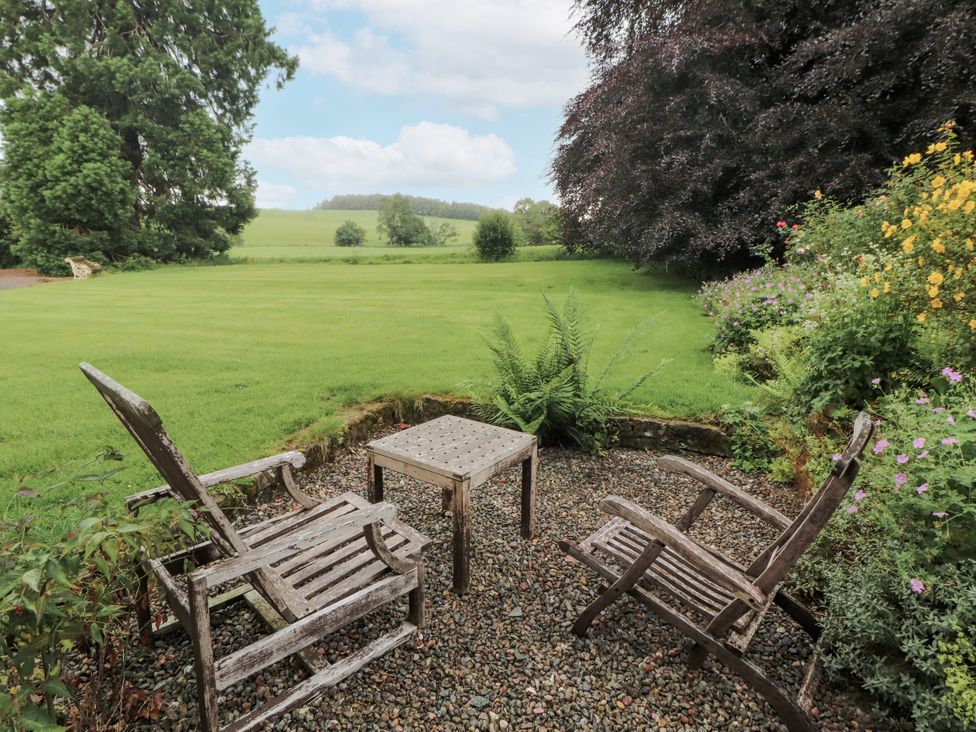 A garden with two chairs and a table at Westward Park near Wigton