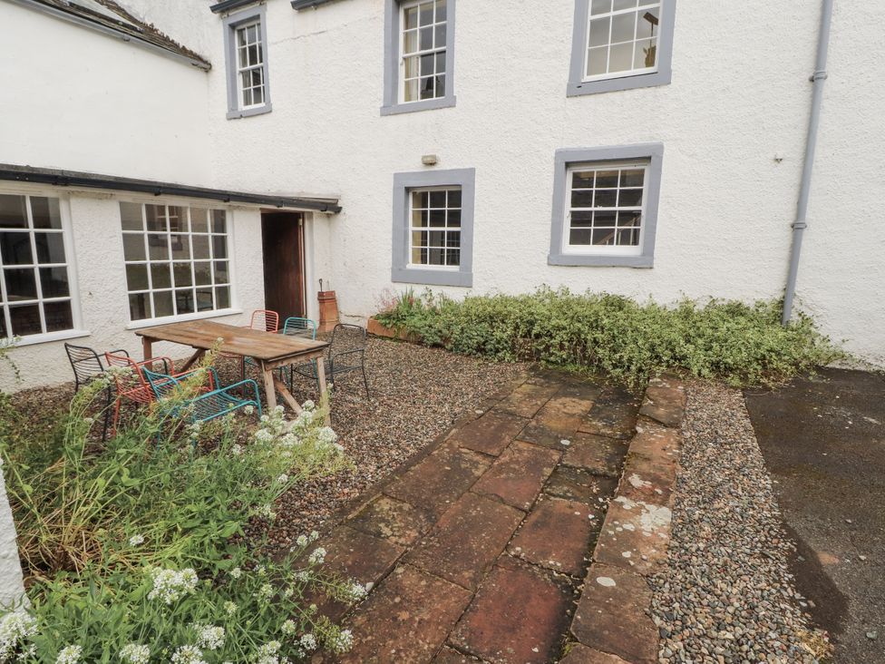 A courtyard with a table and chairs at Westward Park near Wigton