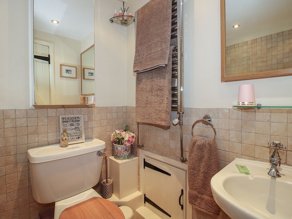 A bathroom with a toilet and sink at Heribert Cottage in Shrewsbury