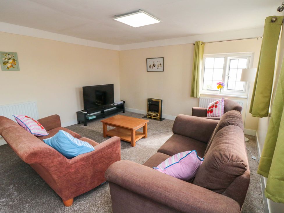 A living room with sofas and a television at Grove Stables House in Yarm