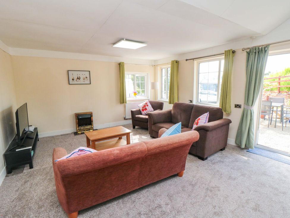 A living room with sofas and a television at Grove Stables House Yarm