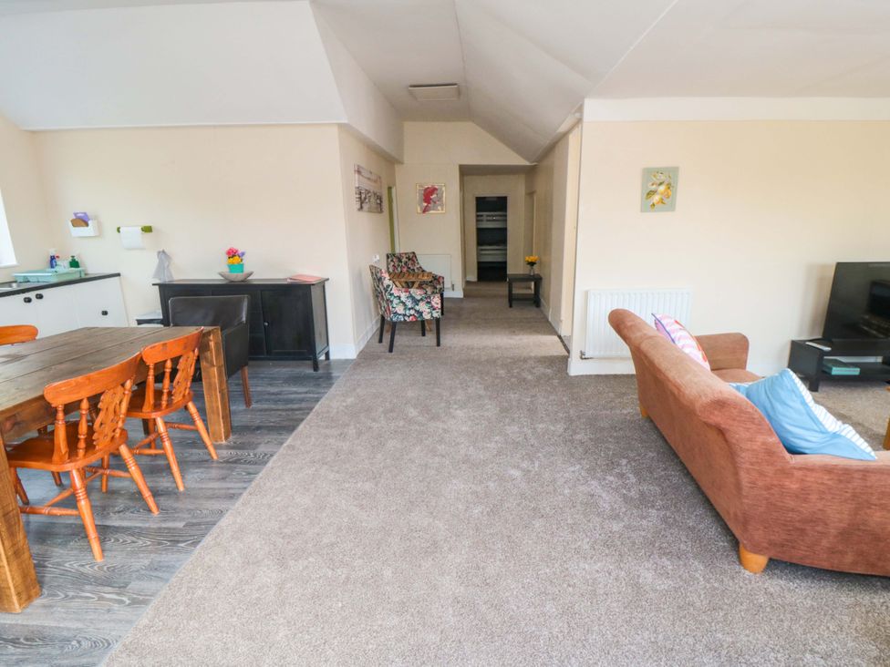A living room with a dining area and a sofa at Grove Stables House in Yarm