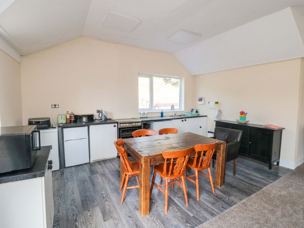 A kitchen with a table and chairs at Grove Stables House in Yarm