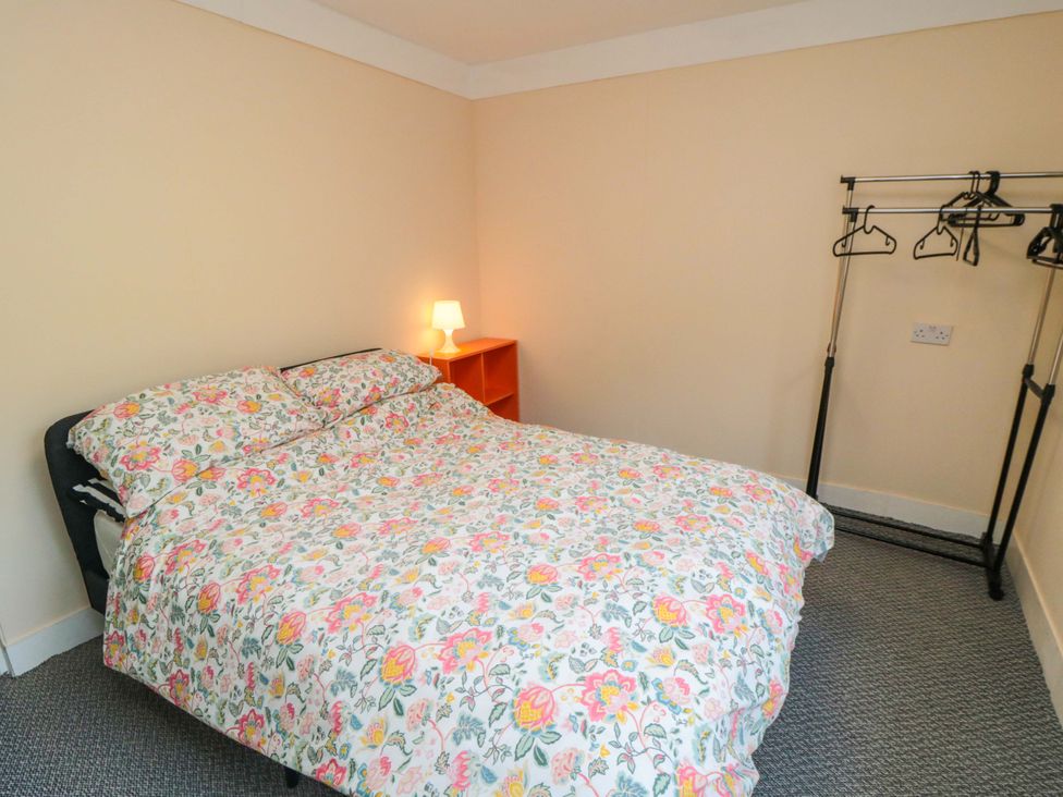 A bedroom with a bed and a lamp at Grove Stables House in Yarm