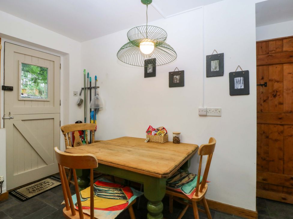 A kitchen with a table and chairs at Waterfall Retreat in Blaenau Ffestiniog