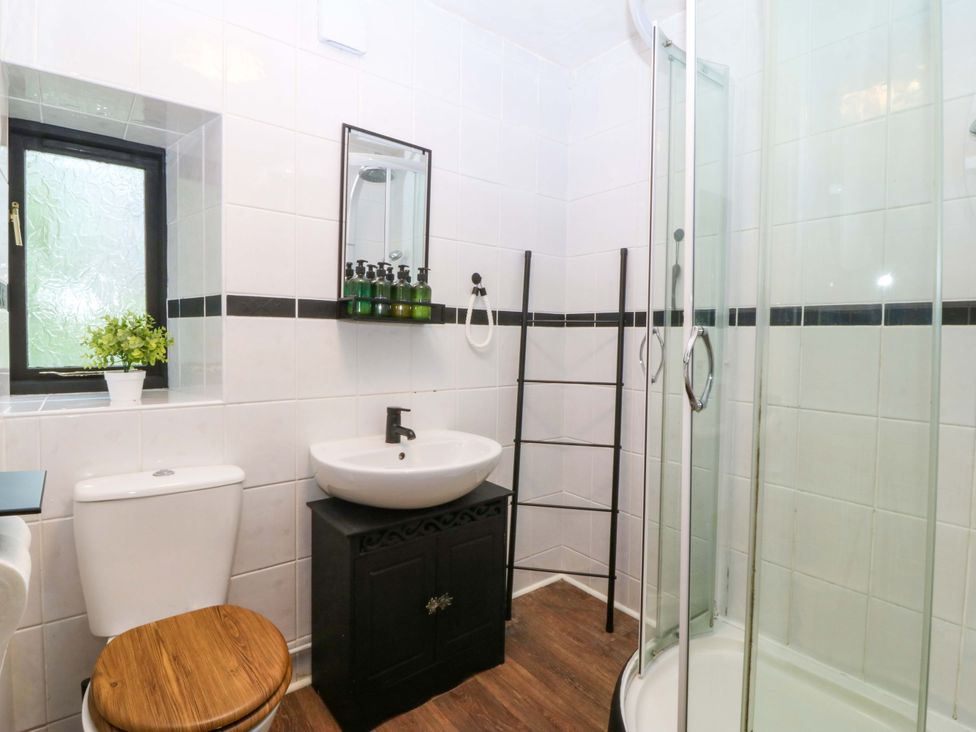 A bathroom with a shower and toilet at Waterfall Retreat in Blaenau Ffestiniog