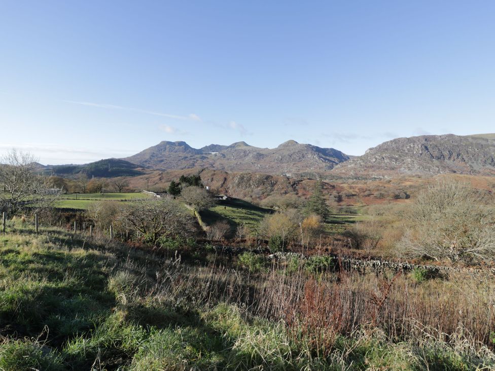 A landscape with mountains and trees at Waterfall Retreat in Blaenau Ffestiniog