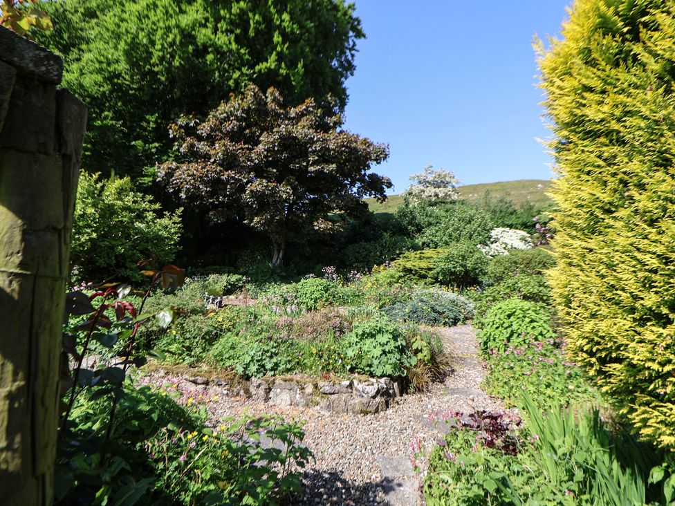 A garden with various plants and trees at Cynynion Uchaf Rhydycroesau near Trefonen