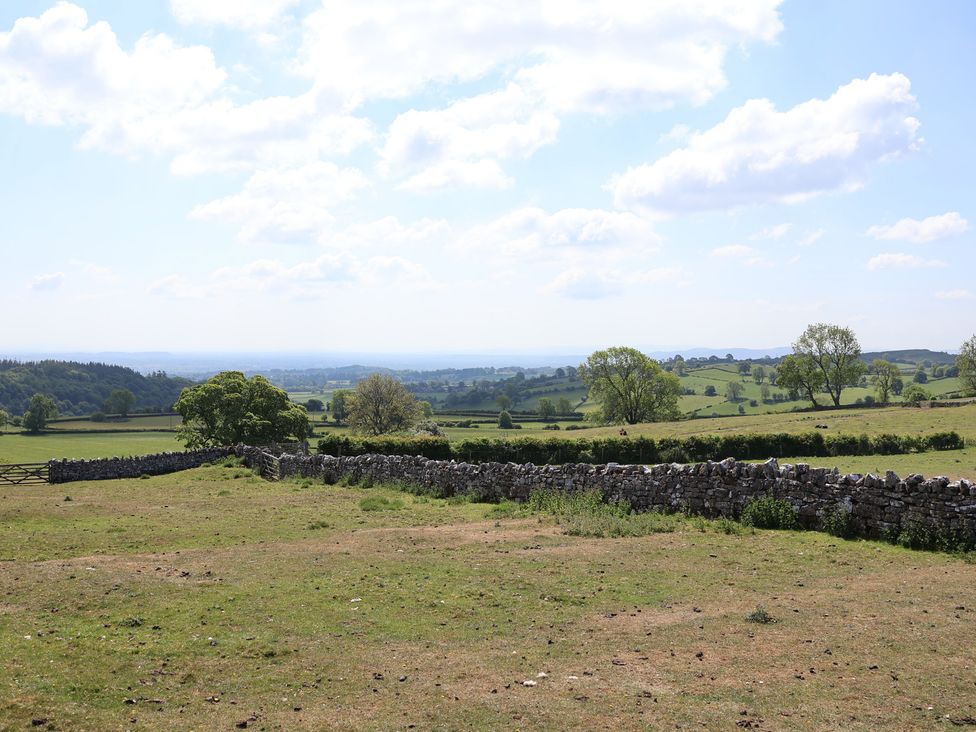 A wide view of fields and stone walls at Cynynion Uchaf Rhydycroesau near Trefonen