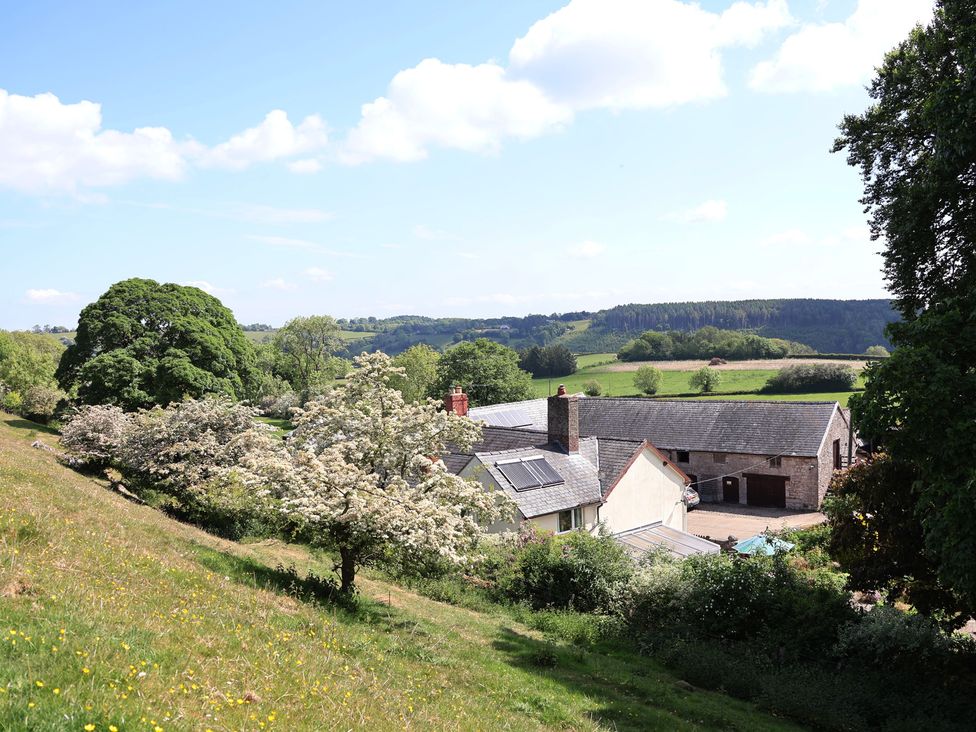 A view of a countryside landscape with buildings and trees at Cynynion Uchaf near Rhydycroesau