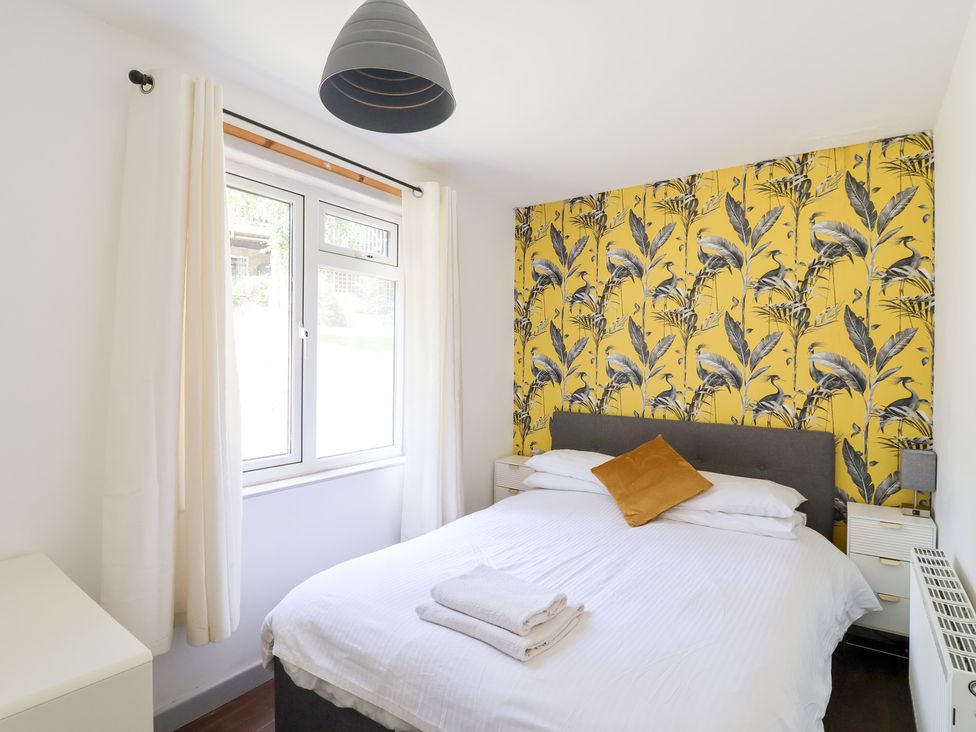 A bedroom with a bed and a window at Valley Lodge 37 St Ann's Chapel, Cornwall