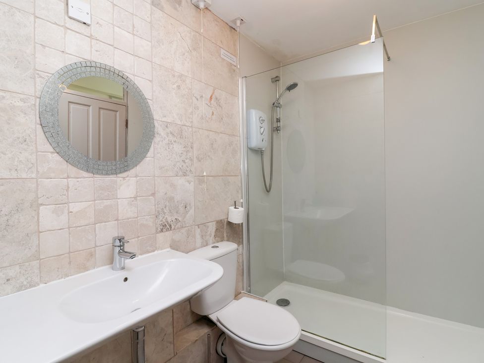 A bathroom with a sink, toilet, and shower at Valley Lodge 37 in St Ann's Chapel, Cornwall