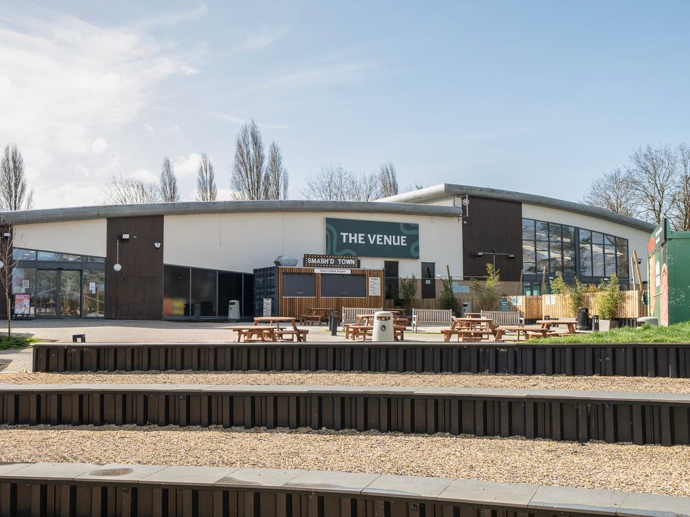 An outdoor area with benches and a building labeled 'The Venue' at Duckling Den - Billing Aquadrome