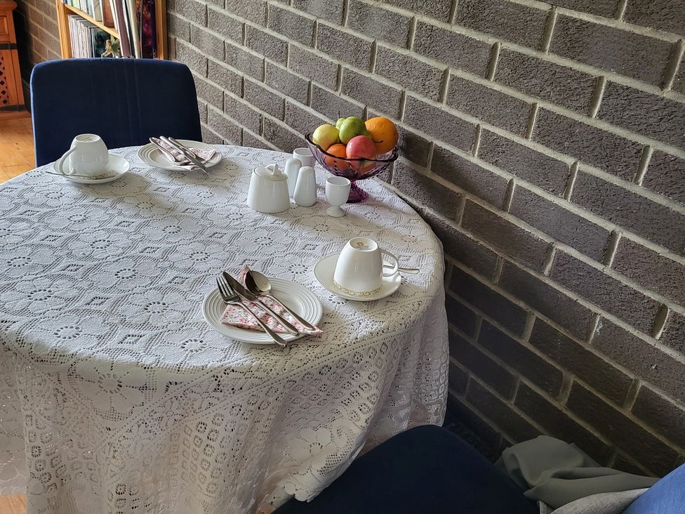A dining table set with tea service and fruit at Beech Lodge in Foulksmills, County Wexford