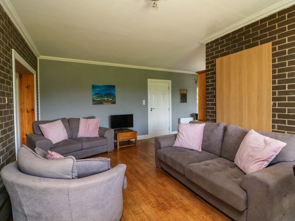 A living room with sofas and a television at Beech Lodge, Foulksmills, County Wexford