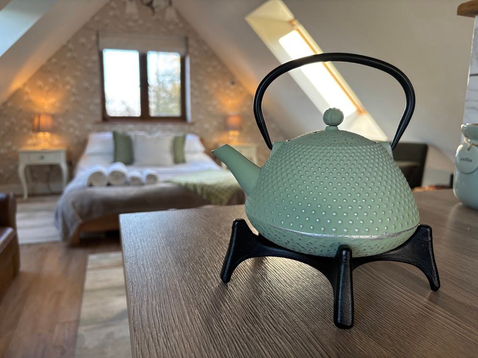 A kettle on a table in a bedroom at Pheasants Rise Apartment in Ross-On-Wye