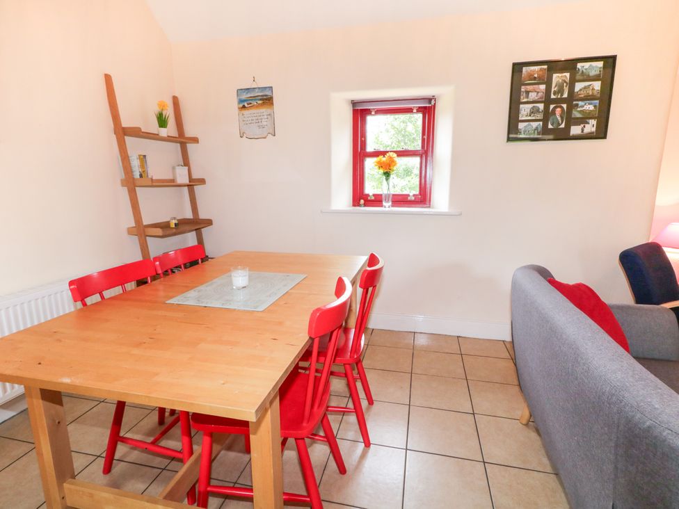 A dining room with a table and chairs at Shane's Cottage in Falcarragh, County Donegal