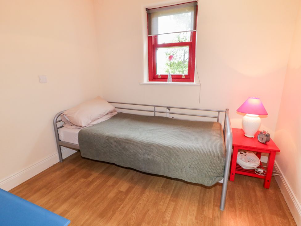 A bedroom with a single bed and a nightstand at Shane's Cottage Falcarragh, County Donegal