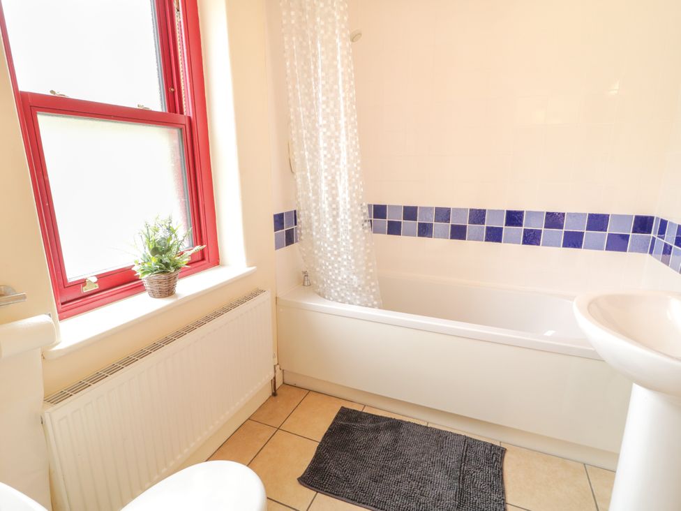 A bathroom with a bathtub and sink at Shane's Cottage in Falcarragh, County Donegal