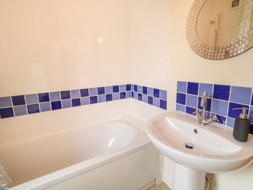 A bathroom with a bathtub and sink at Shane's Cottage Falcarragh County Donegal
