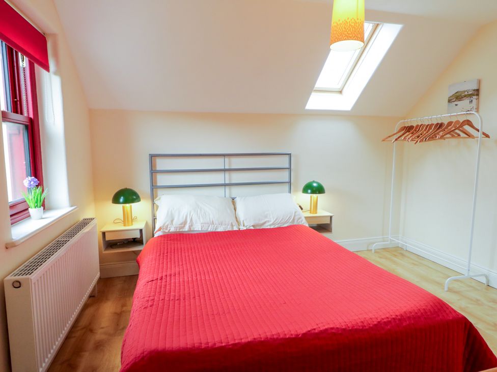 A bedroom with a bed and nightstand at Shane's Cottage, Falcarragh, County Donegal
