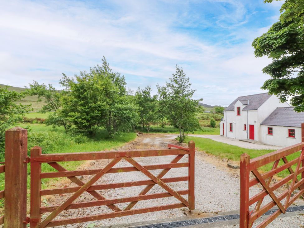 A house with a gate and gravel driveway at Shane's Cottage in Falcarragh, County Donegal