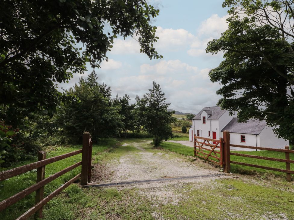 A gravel path leading to a house with a gate at Shane's Cottage in Falcarragh, County Donegal