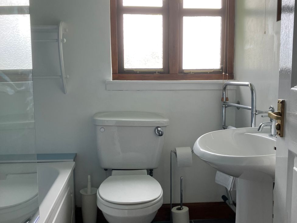 A bathroom with a toilet and wash basin at Island View Lodge near Back of Keppoch
